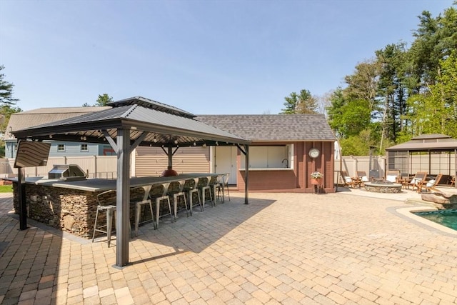 115 Lincoln Rd, Walpole, MA 02081 - view of patio with a fire pit, a fenced backyard, outdoor dry bar, area for grilling, and a gazebo