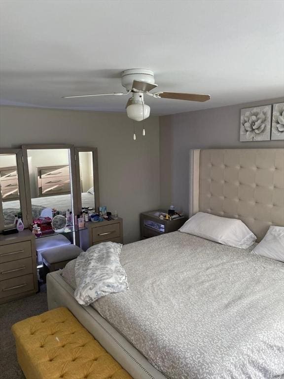 bedroom with dark colored carpet and ceiling fan