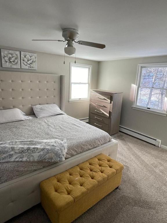 bedroom with carpet floors, a baseboard radiator, and ceiling fan