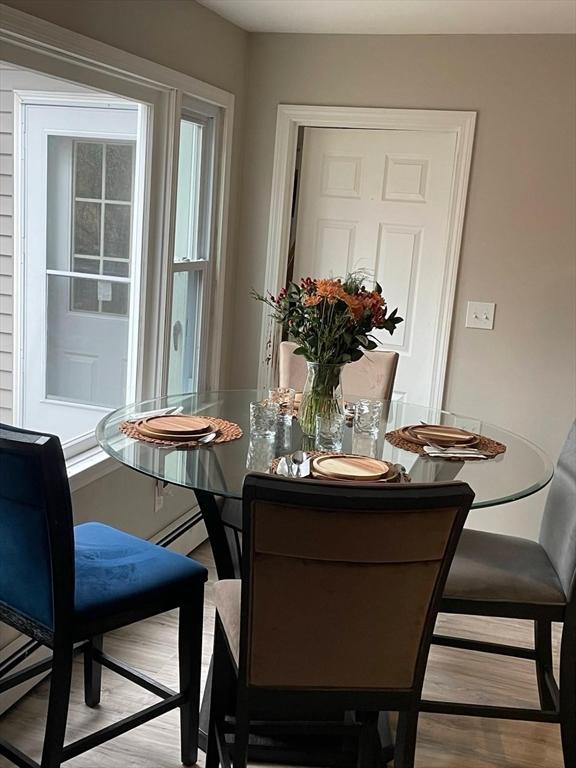 dining room with a wealth of natural light and light wood-type flooring