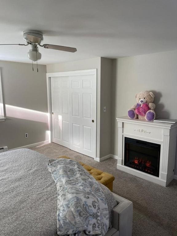 bedroom featuring carpet, ceiling fan, and a closet