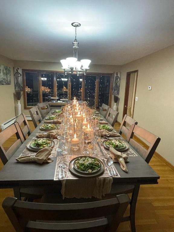 dining space featuring a notable chandelier and hardwood / wood-style flooring