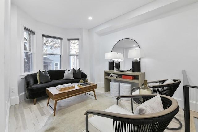 living room featuring baseboards, wood finished floors, and recessed lighting