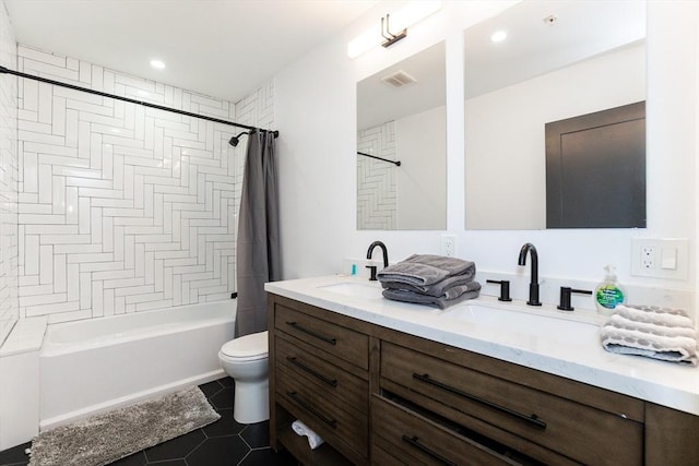 full bathroom featuring visible vents, toilet, tile patterned flooring, shower / bath combo with shower curtain, and a sink