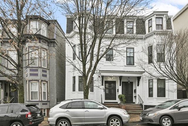 view of front facade featuring mansard roof