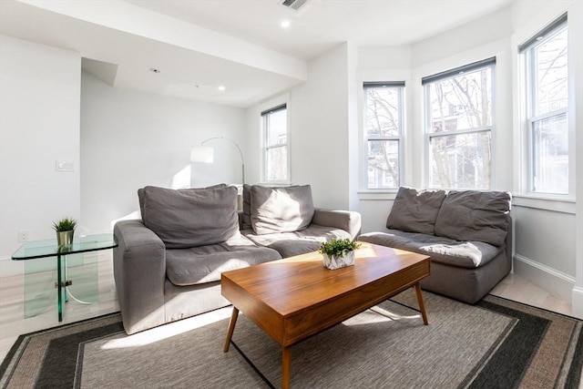 living room with baseboards, visible vents, and recessed lighting