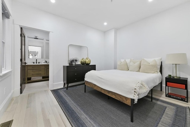 bedroom with recessed lighting, a sink, visible vents, baseboards, and light wood-type flooring