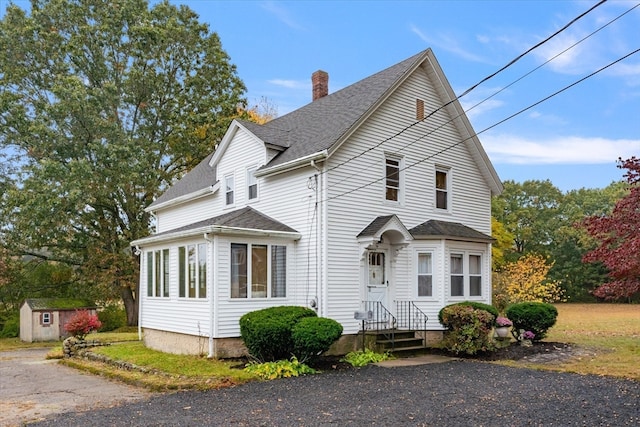 front of property featuring a storage unit