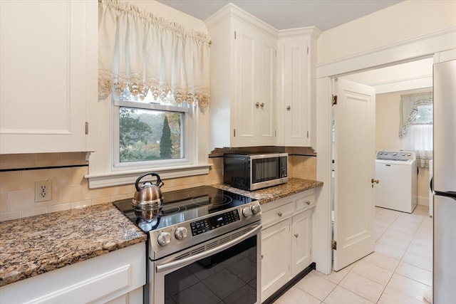 kitchen with light stone counters, white cabinetry, washer / clothes dryer, stainless steel appliances, and decorative backsplash