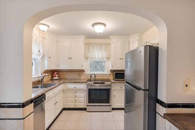 kitchen with a healthy amount of sunlight, white cabinetry, and stainless steel appliances