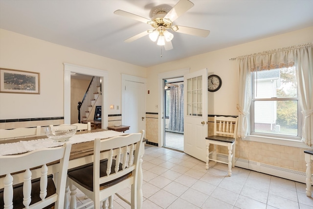 dining space with ceiling fan and light tile patterned flooring