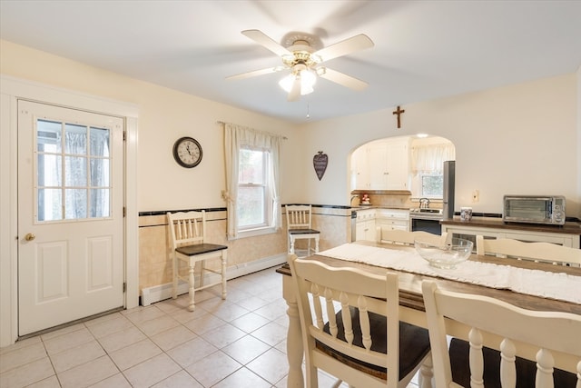 dining area featuring ceiling fan and light tile patterned flooring