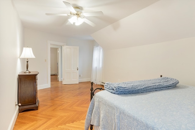 bedroom featuring ceiling fan, light parquet floors, and vaulted ceiling