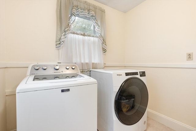 clothes washing area with separate washer and dryer and light tile patterned floors