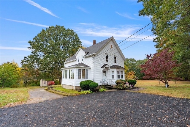 front of property featuring a shed