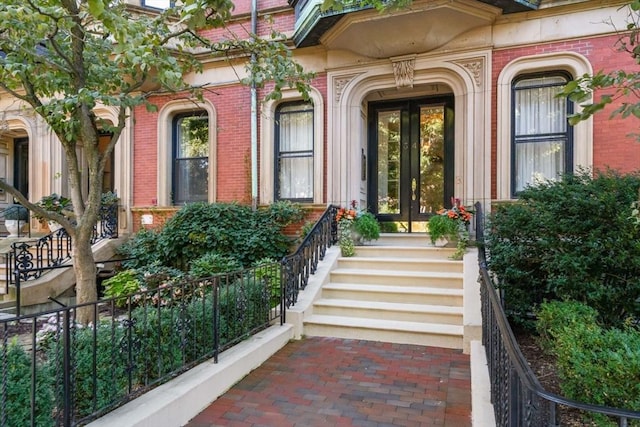 view of exterior entry featuring brick siding