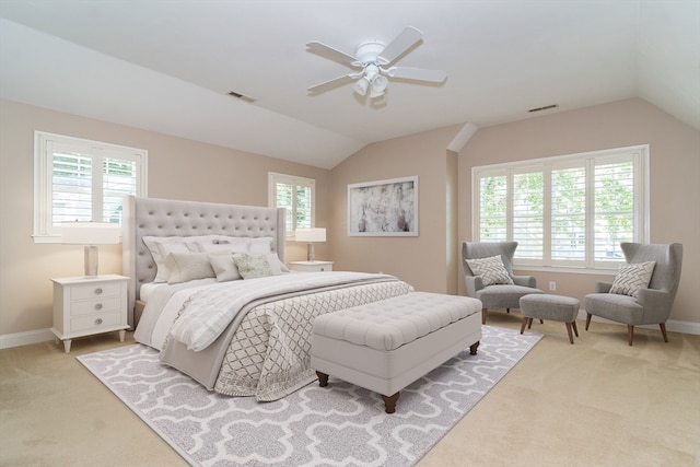 bedroom featuring ceiling fan, lofted ceiling, and multiple windows