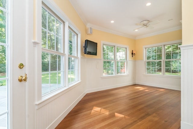 unfurnished sunroom featuring ceiling fan