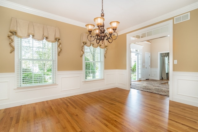 interior space with hardwood / wood-style flooring, crown molding, and a wealth of natural light