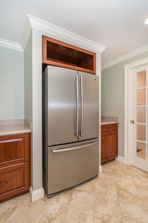 kitchen featuring stainless steel refrigerator and ornamental molding