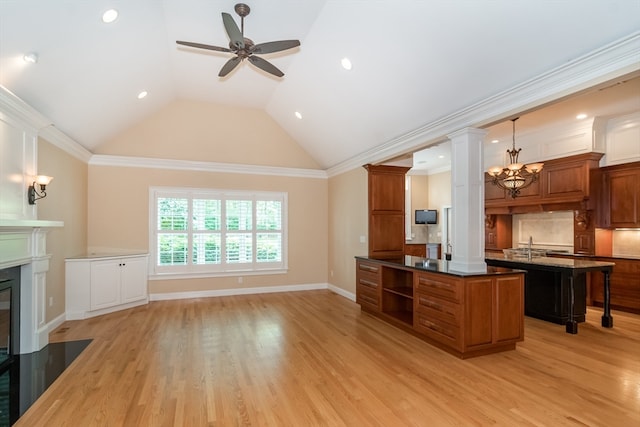 kitchen with decorative backsplash, a center island, light hardwood / wood-style floors, and crown molding