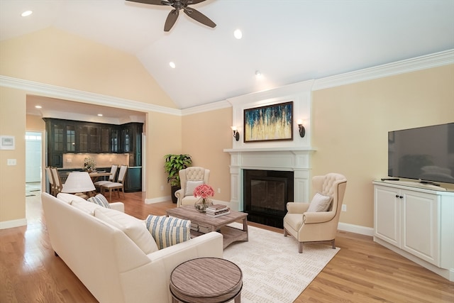 living room featuring light wood-type flooring, crown molding, ceiling fan, and lofted ceiling