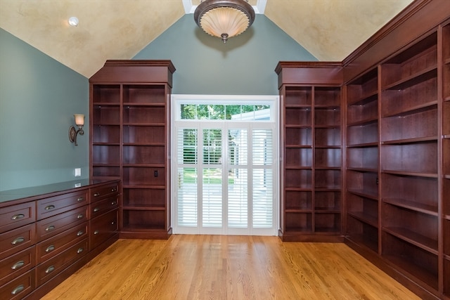 interior space featuring light wood-type flooring and high vaulted ceiling