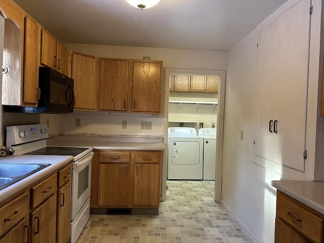 kitchen with white electric stove and washing machine and dryer