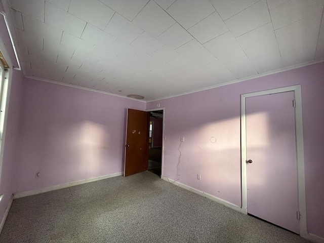 unfurnished bedroom featuring crown molding and carpet flooring