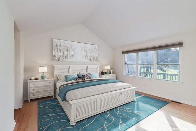 bedroom featuring vaulted ceiling and hardwood / wood-style floors