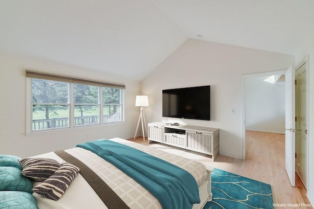 bedroom with lofted ceiling and light hardwood / wood-style floors