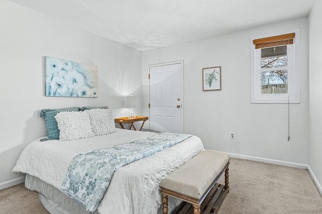 bedroom featuring carpet floors, baseboards, and a textured ceiling