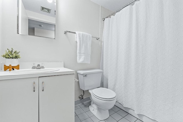 bathroom featuring toilet, a shower with shower curtain, vanity, visible vents, and tile patterned floors