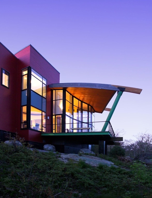 view of back house at dusk