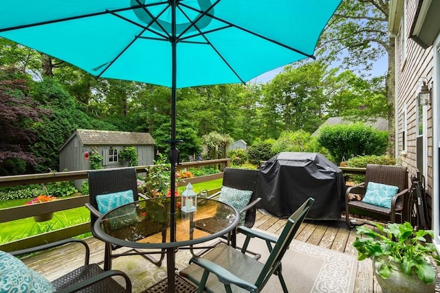 deck with grilling area and a storage shed