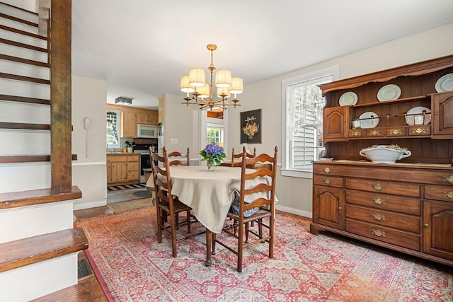 dining space with a chandelier and light hardwood / wood-style flooring