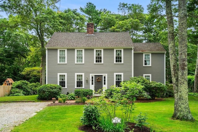 colonial inspired home with a front yard