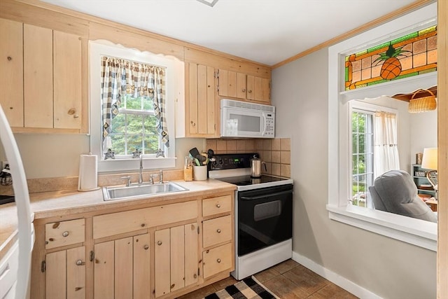 kitchen featuring ornamental molding, white appliances, sink, light brown cabinets, and dark tile patterned flooring