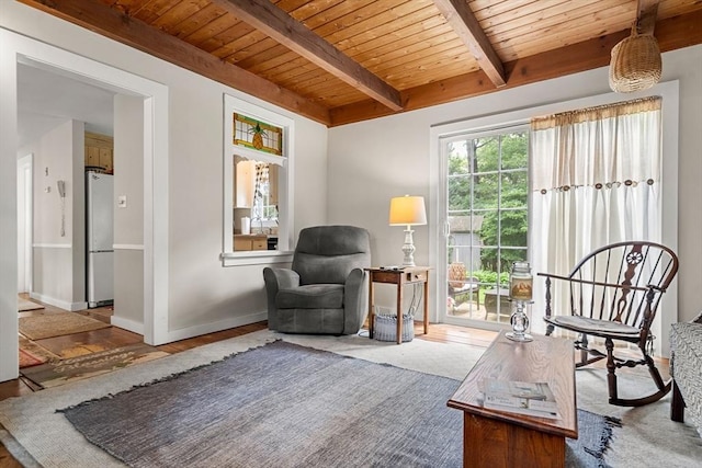 living area featuring beamed ceiling and wooden ceiling