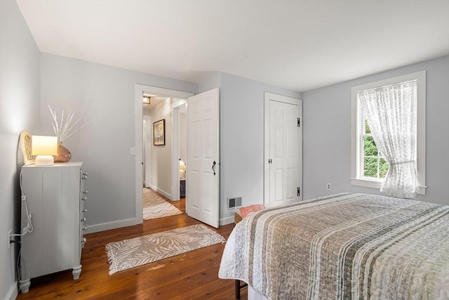 bedroom with hardwood / wood-style flooring