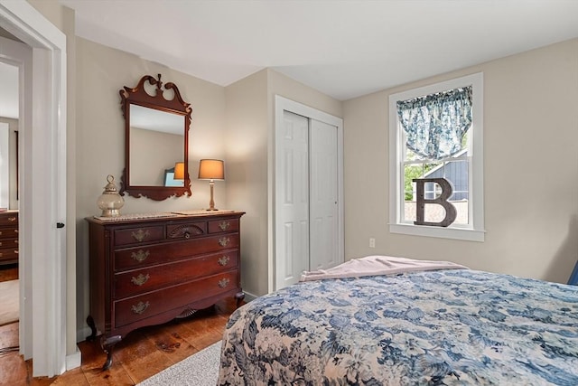 bedroom with light hardwood / wood-style floors and a closet