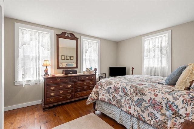 bedroom with dark wood-type flooring