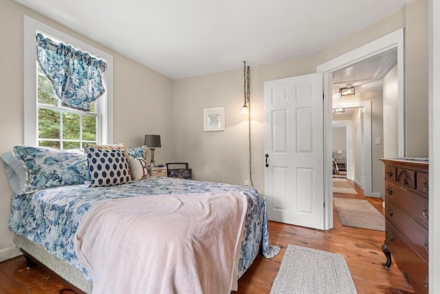 bedroom with hardwood / wood-style flooring