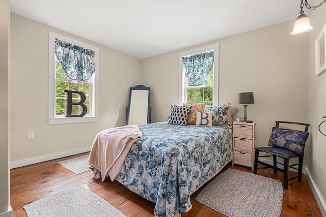 bedroom featuring multiple windows and hardwood / wood-style floors