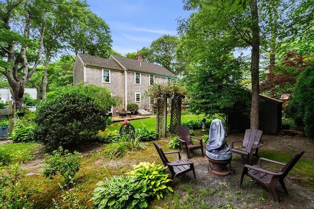 view of yard with an outdoor fire pit