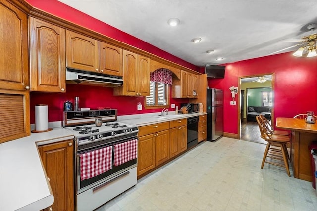 23 Essex St, Revere, MA 02151 - kitchen with stainless steel appliances, under cabinet range hood, a ceiling fan, and light countertops