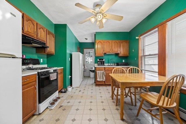23 Essex St, Revere, MA 02151 - kitchen with freestanding refrigerator, gas stove, under cabinet range hood, and light floors