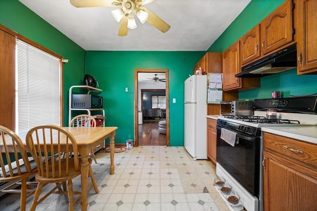 23 Essex St, Revere, MA 02151 - kitchen featuring gas range, freestanding refrigerator, under cabinet range hood, a ceiling fan, and light flooring