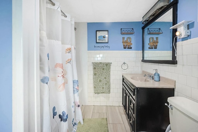8 Scotia St, Salem, MA 01970 - bathroom featuring tile walls, toilet, vanity, a shower with curtain, and a wainscoted wall