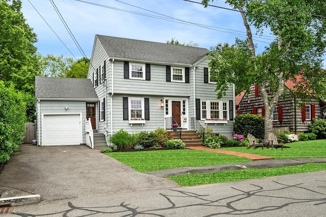 42 Pickwick Rd, Marblehead, MA 01945 - view of front of property with an attached garage, asphalt driveway, a front yard, and a shingled roof